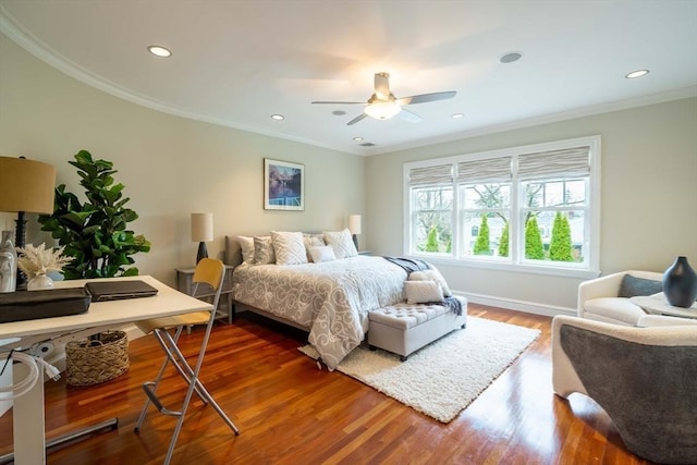 bedroom with dark wood-type flooring, ceiling fan, and ornamental molding