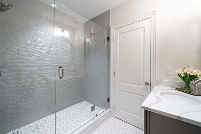 bathroom featuring vanity, walk in shower, and tile patterned floors