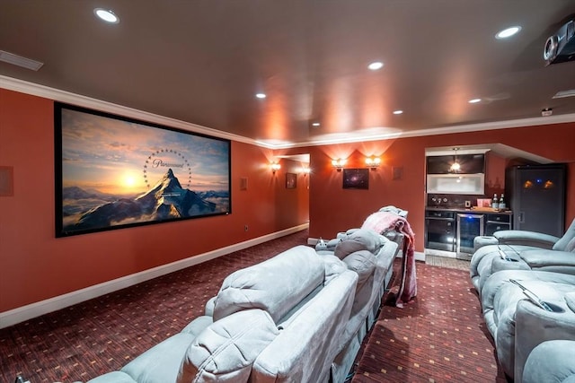 carpeted cinema with bar, beverage cooler, and crown molding