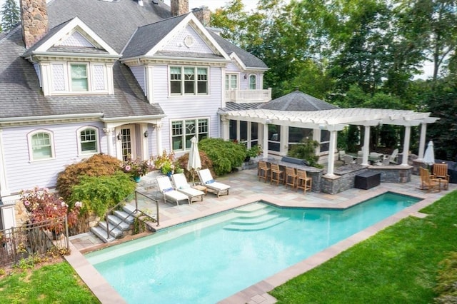 rear view of property featuring a bar, a patio area, a fenced in pool, and a pergola