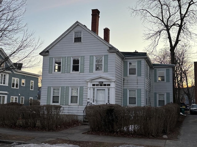 view of front of house featuring a chimney