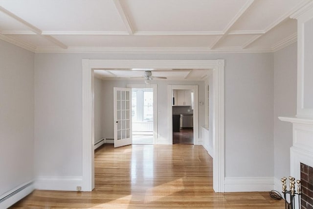 unfurnished living room with baseboards, a fireplace, baseboard heating, and wood finished floors