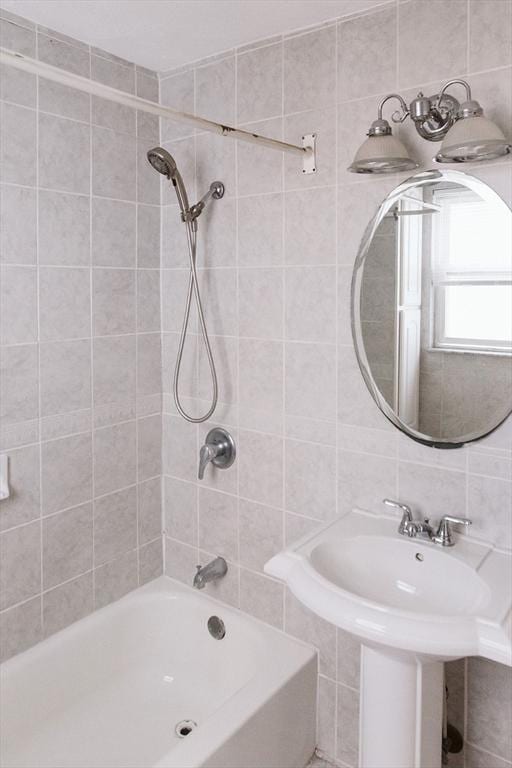 bathroom with a sink and shower / tub combination