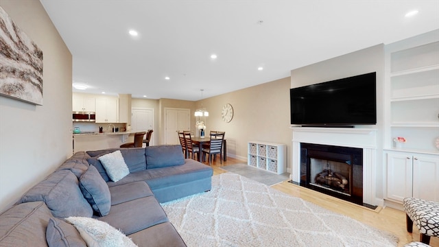 living room with light hardwood / wood-style floors and sink