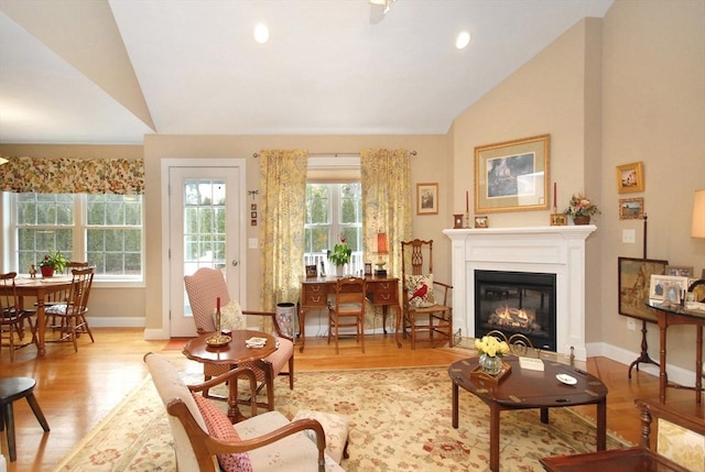 16 John Francis Ln Unit 16, Acton, MA 01720 - living room featuring lofted ceiling, wood finished floors, baseboards, a glass covered fireplace, and recessed lighting