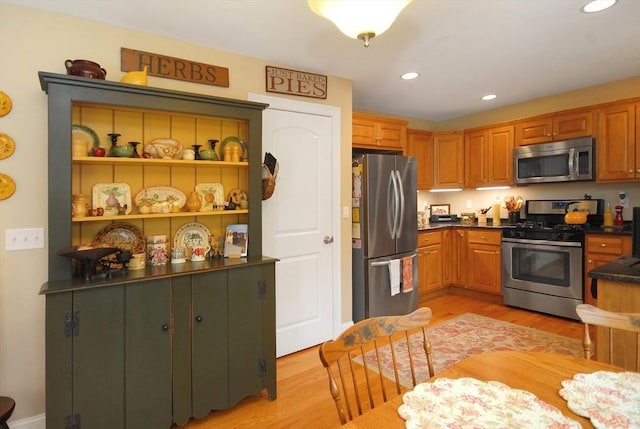 16 John Francis Ln Unit 16, Acton, MA 01720 - kitchen featuring appliances with stainless steel finishes, dark countertops, light wood finished floors, and recessed lighting