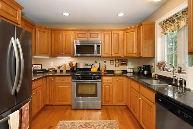 16 John Francis Ln Unit 16, Acton, MA 01720 - kitchen with stainless steel appliances, a sink, light wood-style flooring, dark stone counters, and recessed lighting