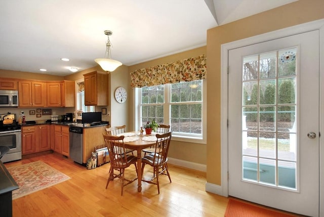 16 John Francis Ln Unit 16, Acton, MA 01720 - kitchen with appliances with stainless steel finishes, light wood finished floors, dark countertops, pendant lighting, and baseboards