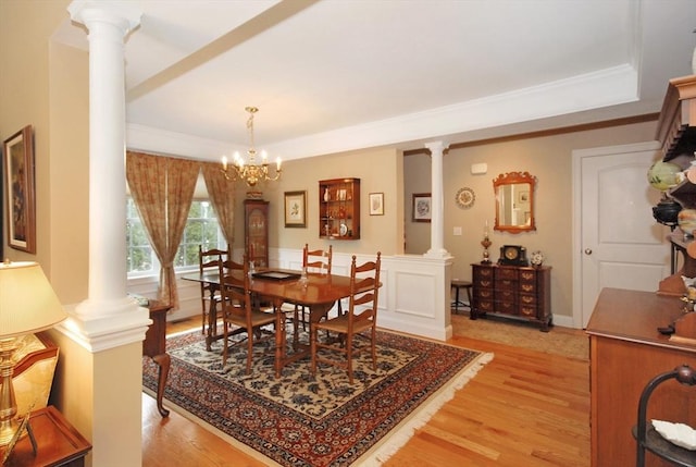 16 John Francis Ln Unit 16, Acton, MA 01720 - dining space featuring a raised ceiling, light wood-style floors, decorative columns, a chandelier, and ornamental molding