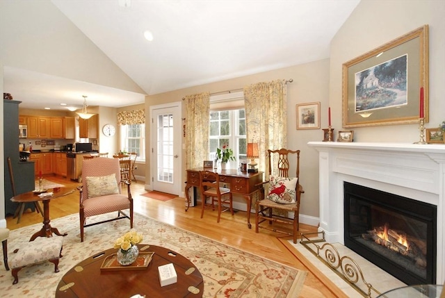 16 John Francis Ln Unit 16, Acton, MA 01720 - living room with lofted ceiling, light wood finished floors, a glass covered fireplace, recessed lighting, and baseboards