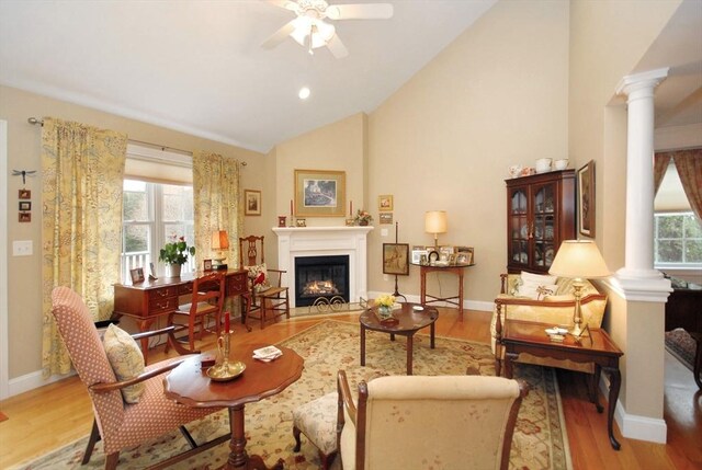 16 John Francis Ln Unit 16, Acton, MA 01720 - living area featuring decorative columns, a ceiling fan, a warm lit fireplace, wood finished floors, and baseboards