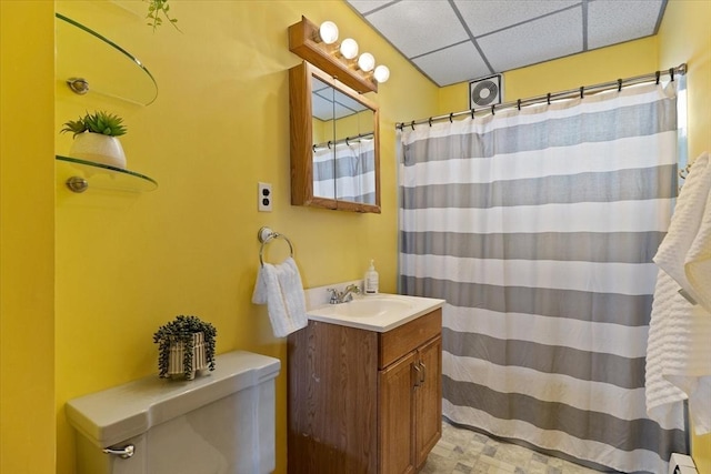 bathroom featuring a drop ceiling, a shower with shower curtain, toilet, a baseboard radiator, and vanity