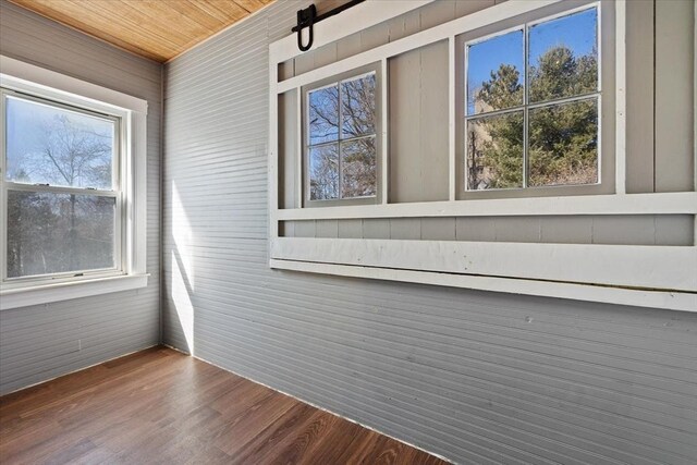 unfurnished sunroom with wooden ceiling