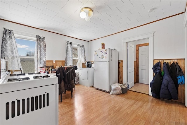 interior space with wainscoting, plenty of natural light, and light wood finished floors