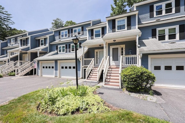 219 Heritage Dr Unit 219, Northbridge, MA 01588 - multi unit property featuring asphalt driveway, stairway, covered porch, and a garage
