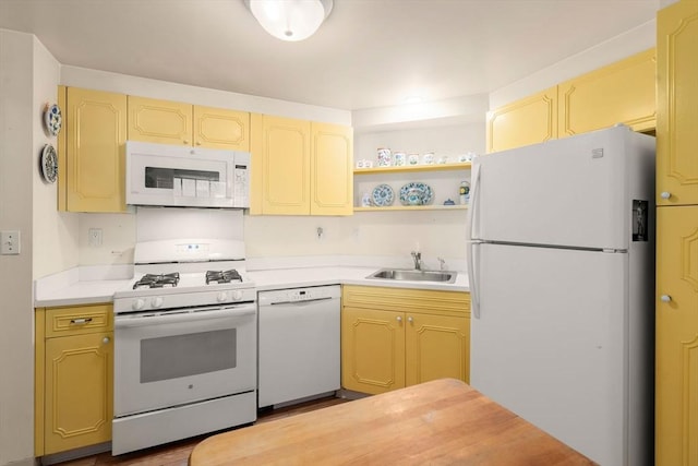 kitchen featuring a sink, open shelves, white appliances, and light countertops