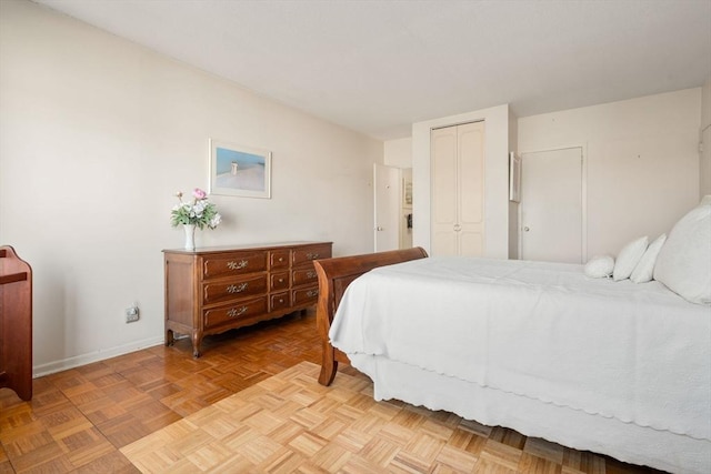 bedroom with baseboards and a closet