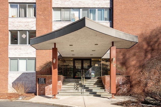 doorway to property with brick siding