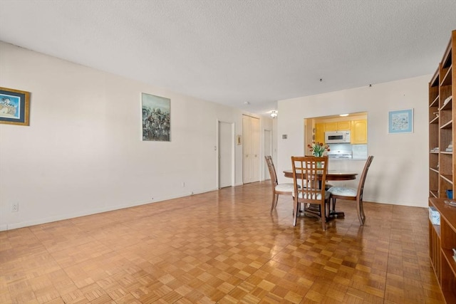 dining area featuring a textured ceiling