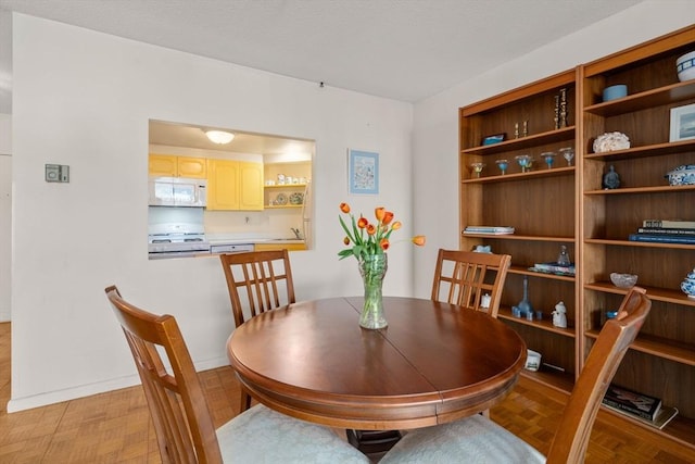 dining area featuring baseboards