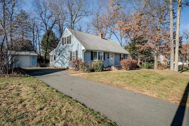 view of front facade featuring a garage, an outdoor structure, and a front lawn