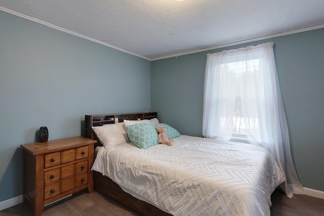 bedroom with crown molding and dark wood-type flooring