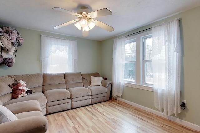 living room featuring light hardwood / wood-style floors and ceiling fan