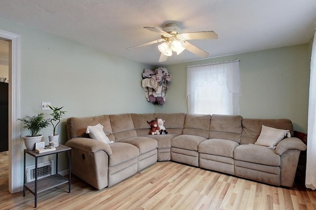 living room with ceiling fan and light hardwood / wood-style flooring