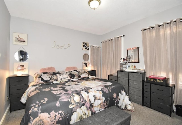 bedroom with carpet floors and baseboards