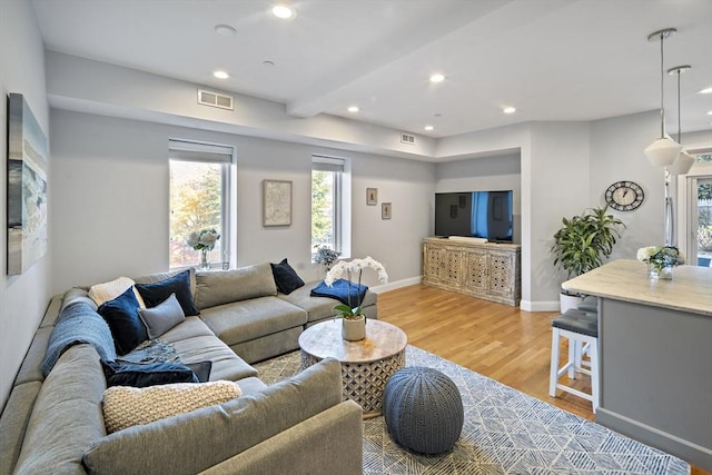 living room with recessed lighting, baseboards, visible vents, and light wood finished floors