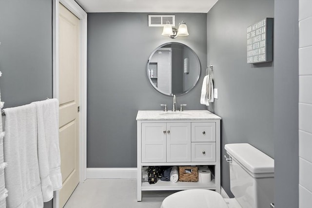 bathroom featuring toilet, baseboards, visible vents, and vanity