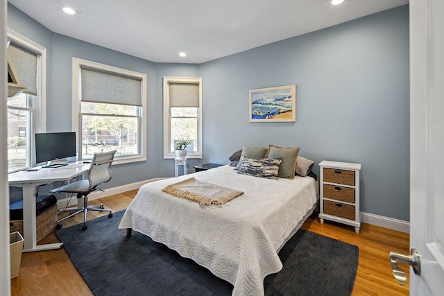 bedroom featuring baseboards and wood finished floors