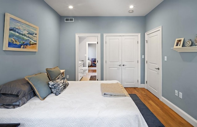 bedroom featuring recessed lighting, a closet, visible vents, wood finished floors, and baseboards