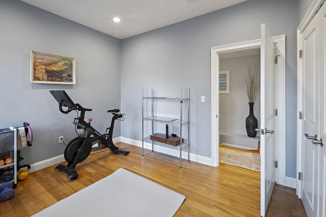 workout area with recessed lighting, wood finished floors, and baseboards