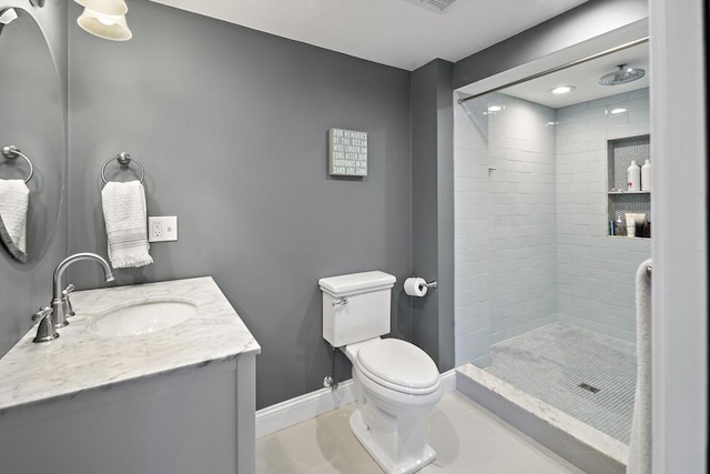 full bath with a stall shower, toilet, vanity, and baseboards