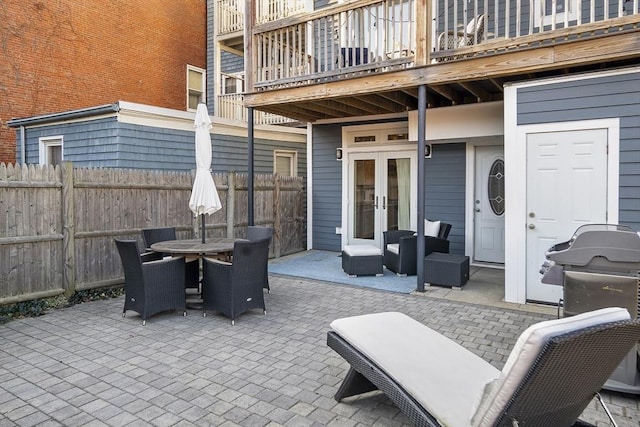 view of patio / terrace featuring fence, outdoor dining area, and french doors