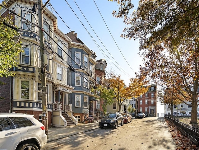 view of building exterior featuring a residential view and fence