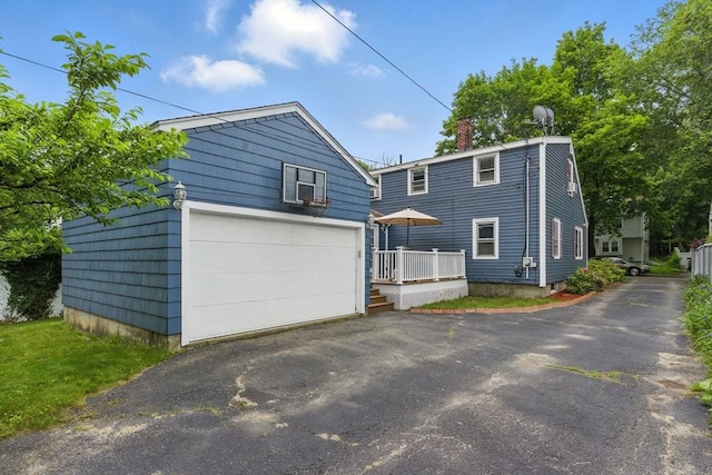33 Walworth St, Worcester, MA 01602 - view of front facade with an outdoor structure, a garage, and a chimney