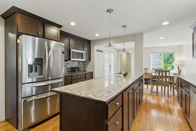 33 Walworth St, Worcester, MA 01602 - kitchen featuring stainless steel appliances, a center island, dark brown cabinetry, light wood finished floors, and recessed lighting