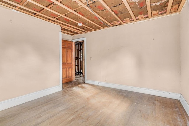 basement with light hardwood / wood-style floors