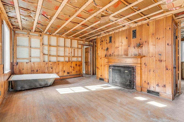 unfurnished living room with hardwood / wood-style flooring and baseboard heating