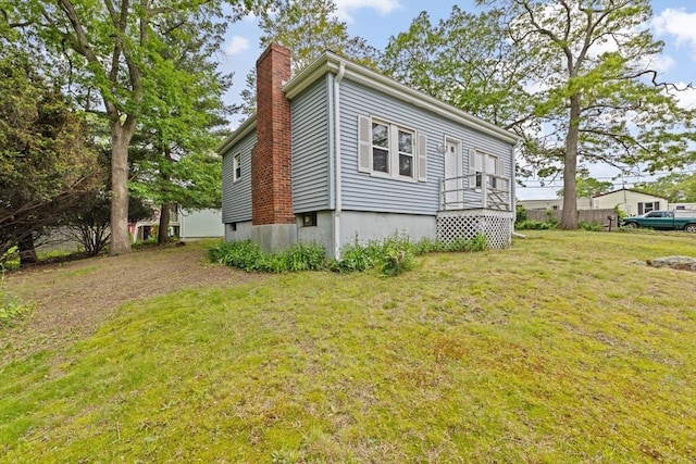 15 Rand St, Randolph, MA 02368 - view of home's exterior with a chimney and a lawn