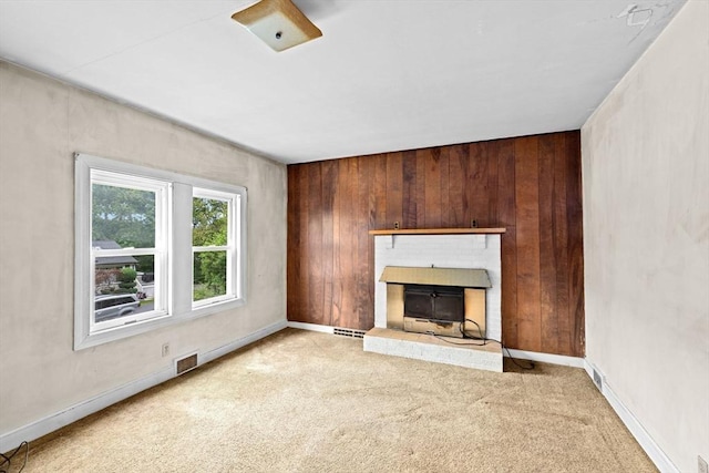15 Rand St, Randolph, MA 02368 - unfurnished living room with carpet floors, wooden walls, and a fireplace