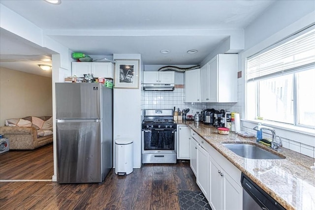 kitchen featuring dark wood-type flooring, sink, light stone counters, white cabinetry, and stainless steel appliances