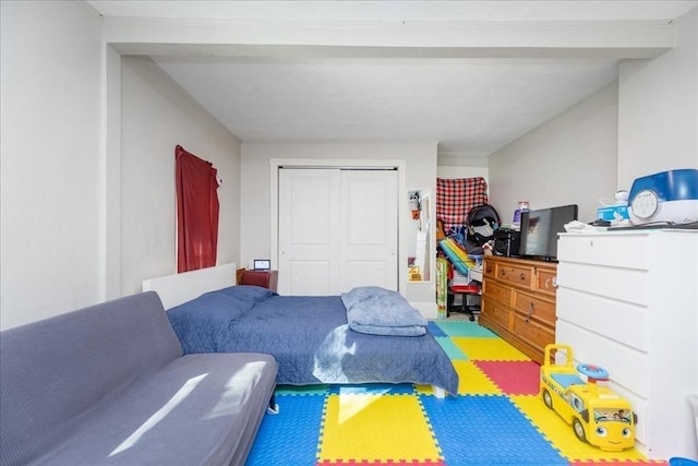 playroom featuring beamed ceiling