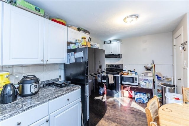 kitchen featuring dark hardwood / wood-style flooring, backsplash, black fridge, white cabinetry, and stainless steel range with electric cooktop