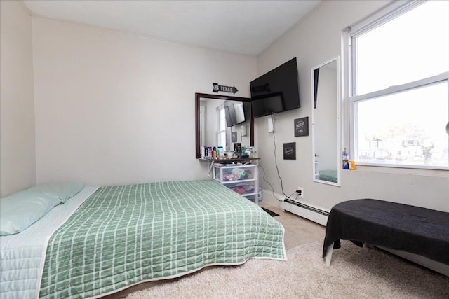 bedroom with carpet floors and a baseboard radiator