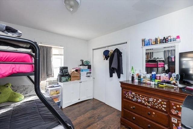 bedroom featuring dark hardwood / wood-style floors and a closet