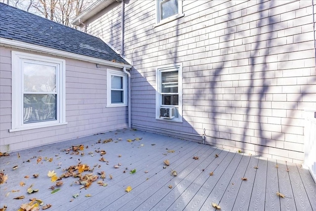 wooden deck featuring cooling unit