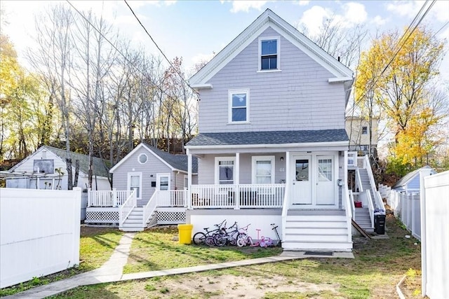 back of house with a porch and a yard